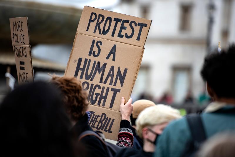 Protesters hold a sign saying 'Protest is a human right'