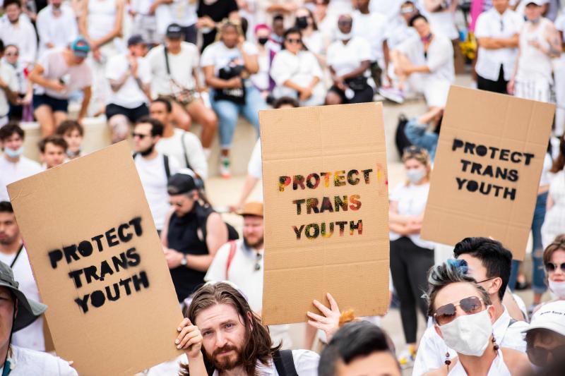 People holding signs that say "Protect Trans Youth"